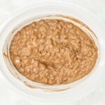 A crockpot filled with chocolate nut cluster candy makings.