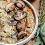 A bowl of wild rice soup with mushrooms and sage.