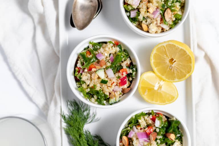 Three bowls of quinoa salad on a white plate.