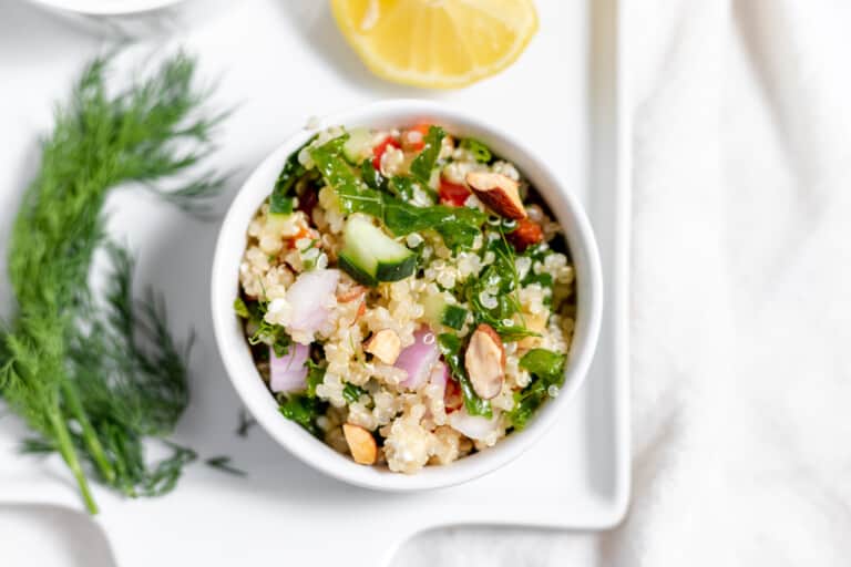A bowl of quinoa salad on a white plate.