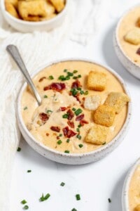 A bowl of cheese soup with croutons and croutons.