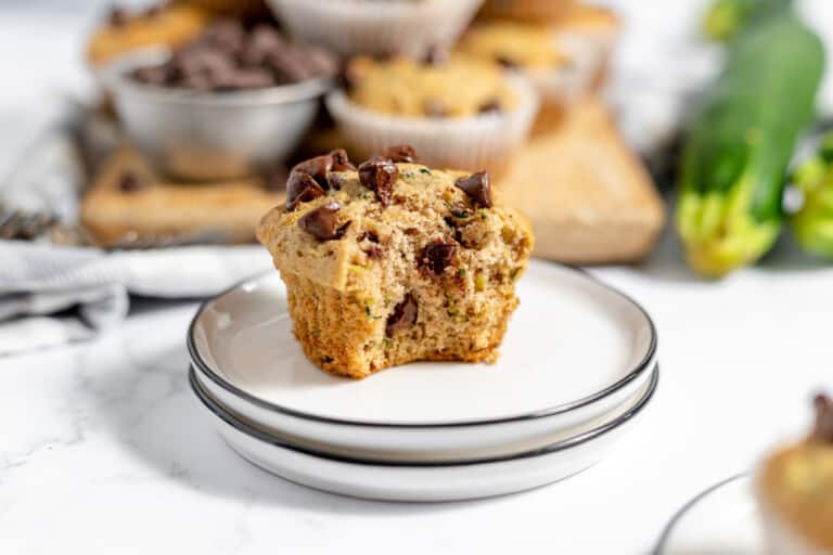 Zucchini muffins with chocolate chips on a plate.