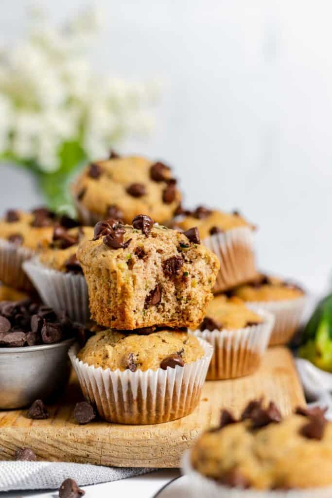 A stack of chocolate chip muffins on a cutting board.