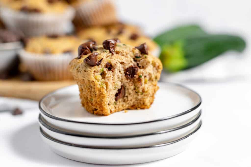 Zucchini muffins with chocolate chips on a plate.
