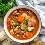 A bowl of cowboy stew with potatoes and carrots.