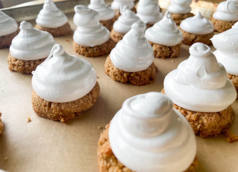 A tray of mallowmars with meringue on top.