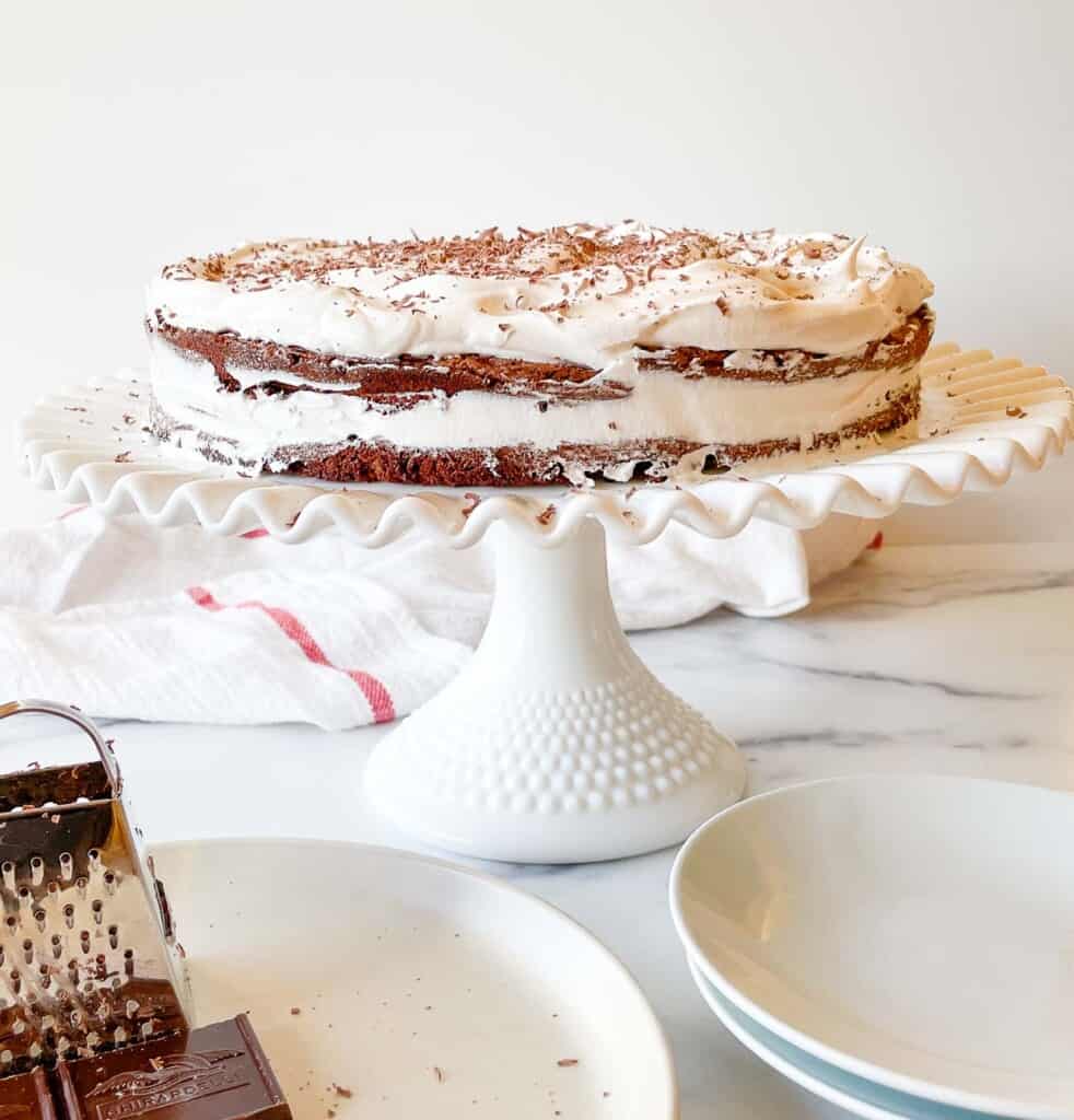 A Mocha Torte is sitting on a cake stand.