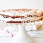 A Mocha Torte is sitting on a cake stand.