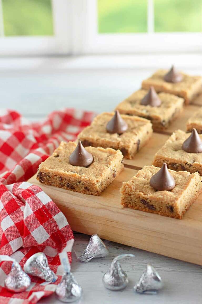 Chocolate chip cookie bars on a cutting board.