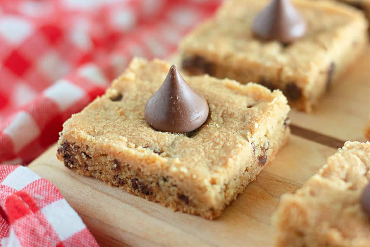 Chocolate chip cookie bars on a cutting board.