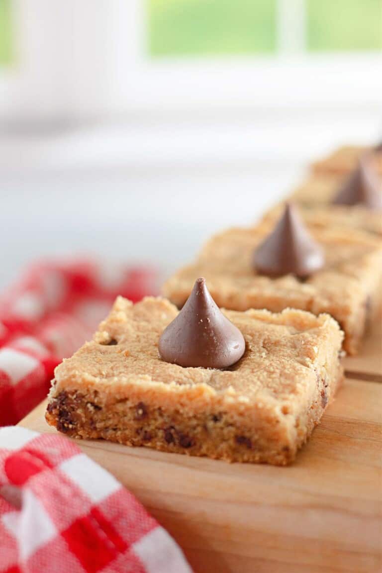 Chocolate chip cookie bars on a cutting board.