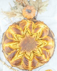 A pumpkin braided bread on a white plate.