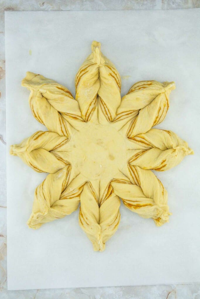 A star shaped dough on a baking sheet.