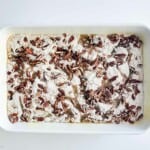 A white baking dish filled with sweet potato and cake mix.