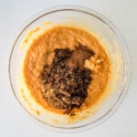 A bowl filled with a mixture of chocolate and pumpkin.