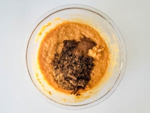 A bowl filled with a mixture of chocolate and pumpkin.