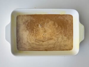 A white baking dish with sweet potato in it.