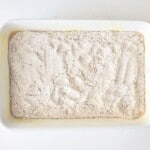 A white baking dish filled with cake mix.