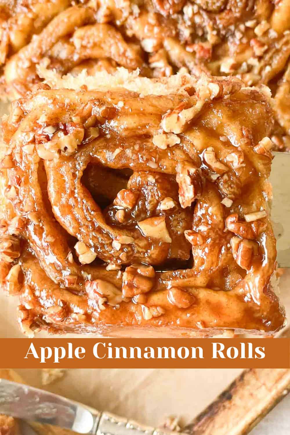 On a plate with a fork, there are delicious apple cinnamon rolls.
