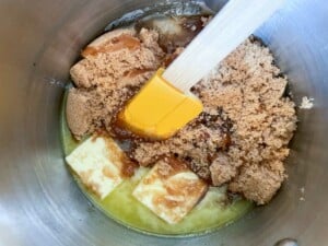 A mixture of butter and sugar in a metal bowl.