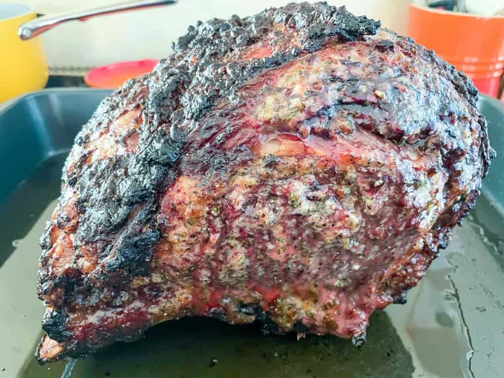 A prime rib roast sitting on a baking sheet.