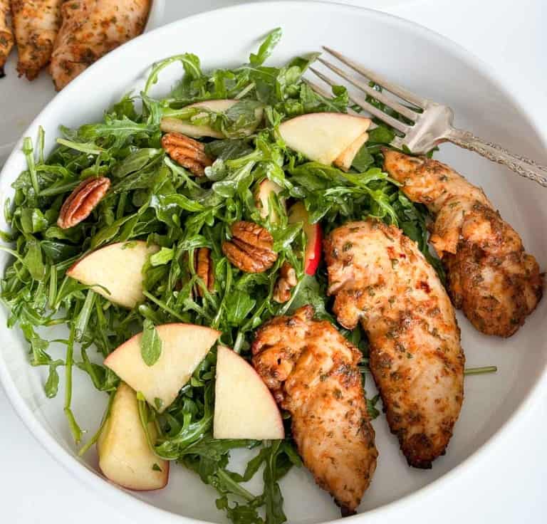 Baked ranch chicken salad with apples and pecans in a white bowl.