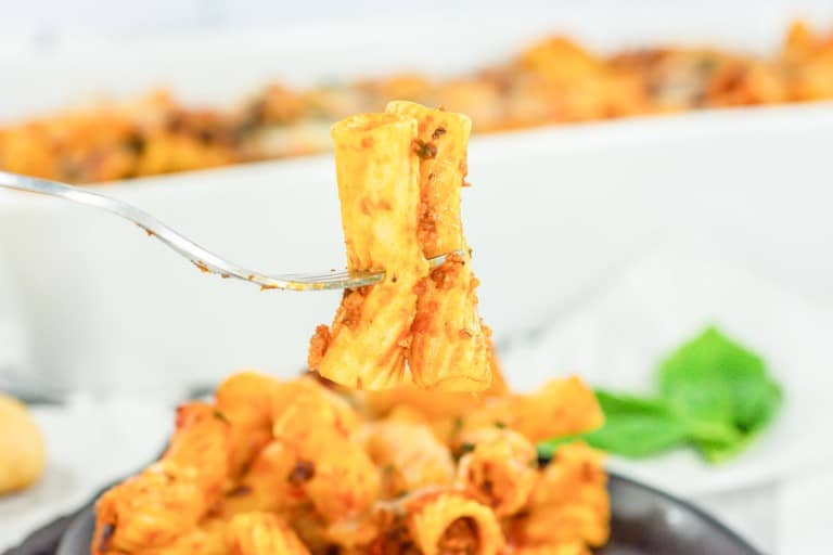 A fork is being used to pick up a piece of pasta.