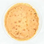 A pie in a glass dish on a white background.