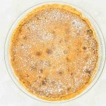 A pumpkin pie with powdered sugar on top.