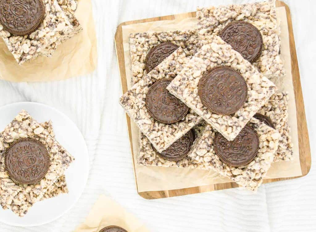 Oreo cookie bars on a wooden cutting board.