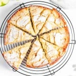 A slice of apple cake on a cooling rack.