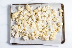 Cauliflower florets on a baking sheet.