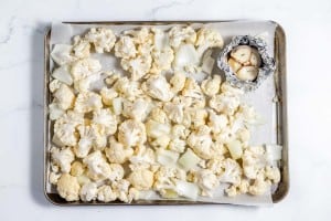 Cauliflower florets on a baking sheet.