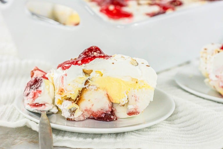 A plate with a scoop of ice cream and strawberries.