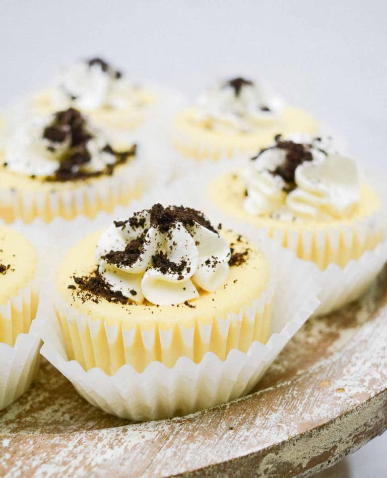 A slice of mini cookies and cream cheesecakes on a paper napkin with a fork.