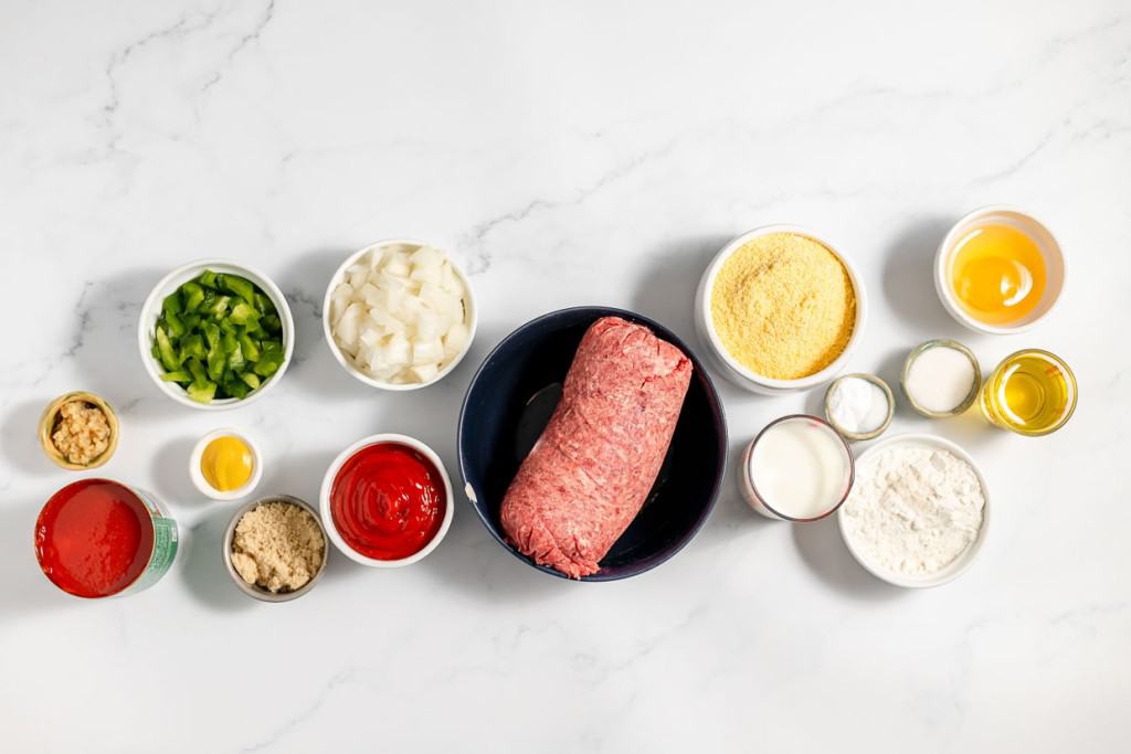 Various ingredients for a recipe neatly organized on a marble countertop.