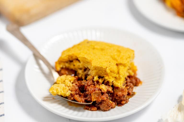 A plate with a serving of cornbread-topped chili.