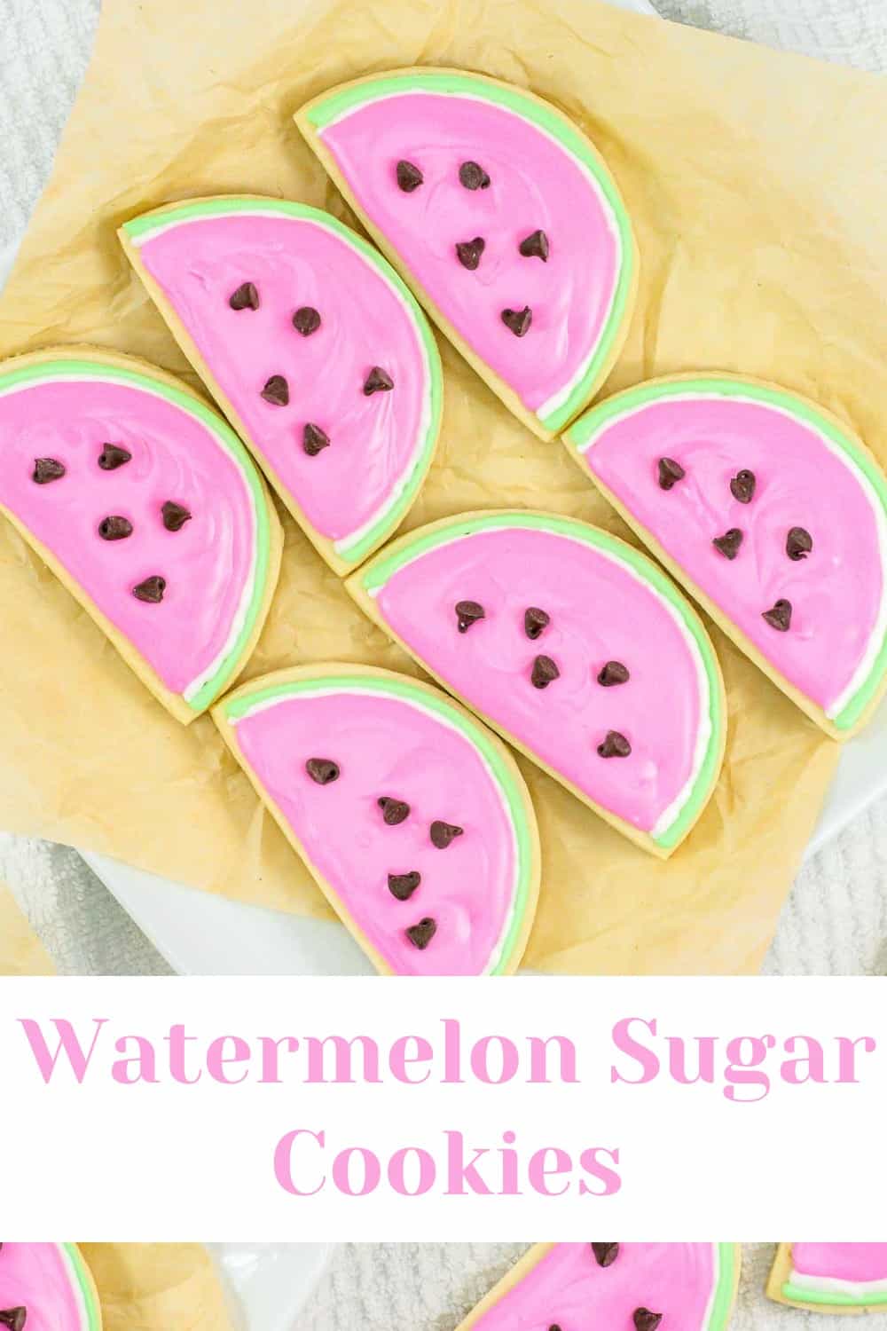 Colorful watermelon-shaped sugar cookies decorated with pink and green icing and chocolate chips.