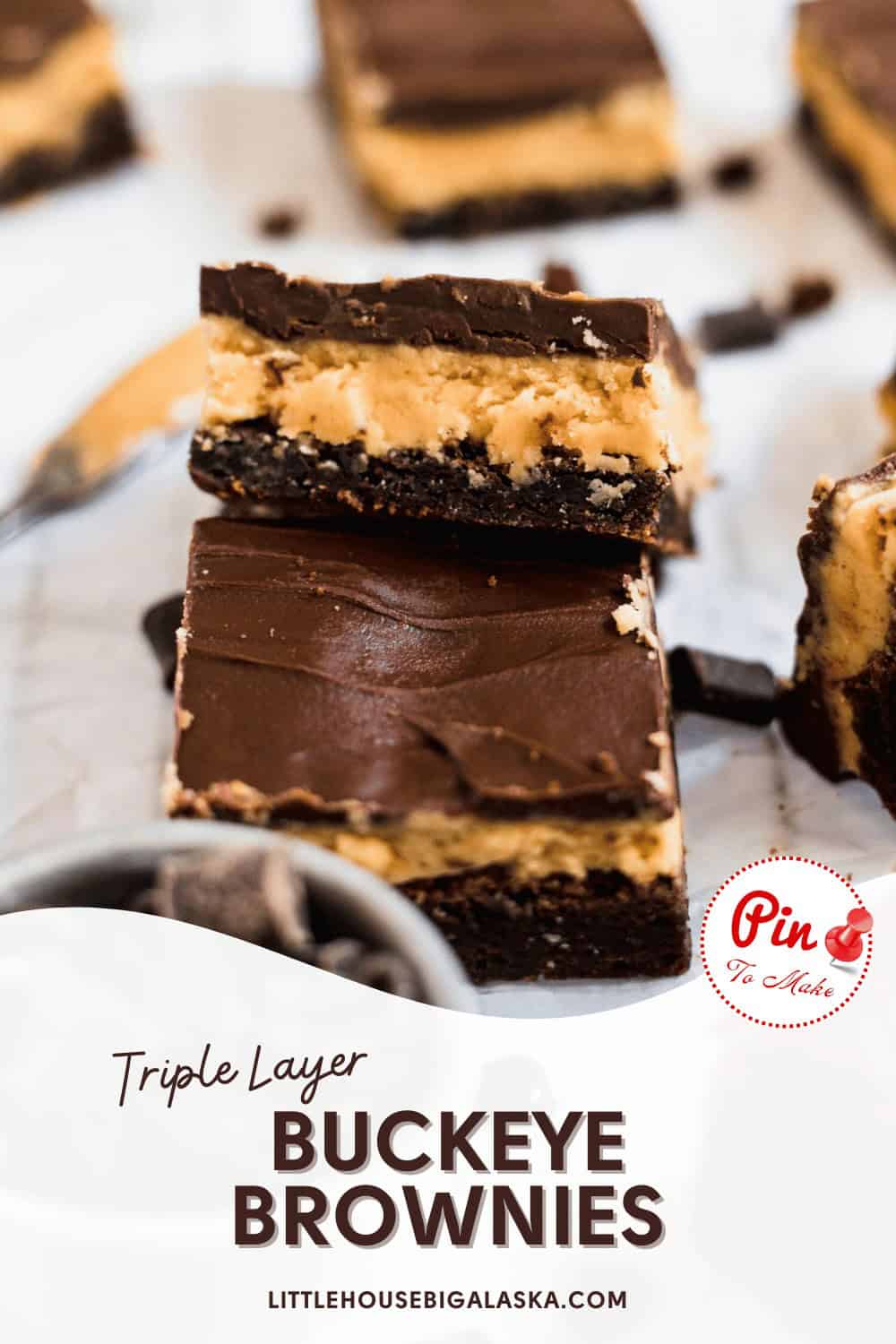 A close-up of triple layer buckeye brownies featuring a chocolate base, peanut butter filling, and chocolate topping. A red "Pin to Make" button and website "littlehousebigalaska.com" are shown.