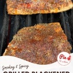 Two pieces of seasoned salmon fillets are grilling on a barbecue. The text reads "Smokey & Spicy Grilled Blackened Salmon" with a website URL at the bottom: littlehousebigalaska.com.
