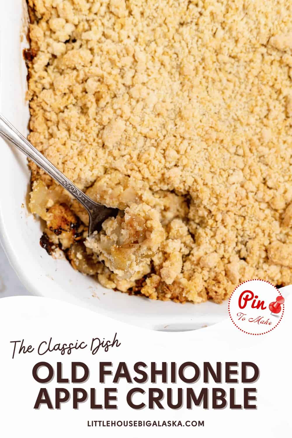 A baked apple crumble with a golden crumb topping in a rectangular dish, a spoon scooping a portion. Text reads "The Classic Dish - Old Fashioned Apple Crumble" and "LITTLEHOUSEBIGALASKA.COM.