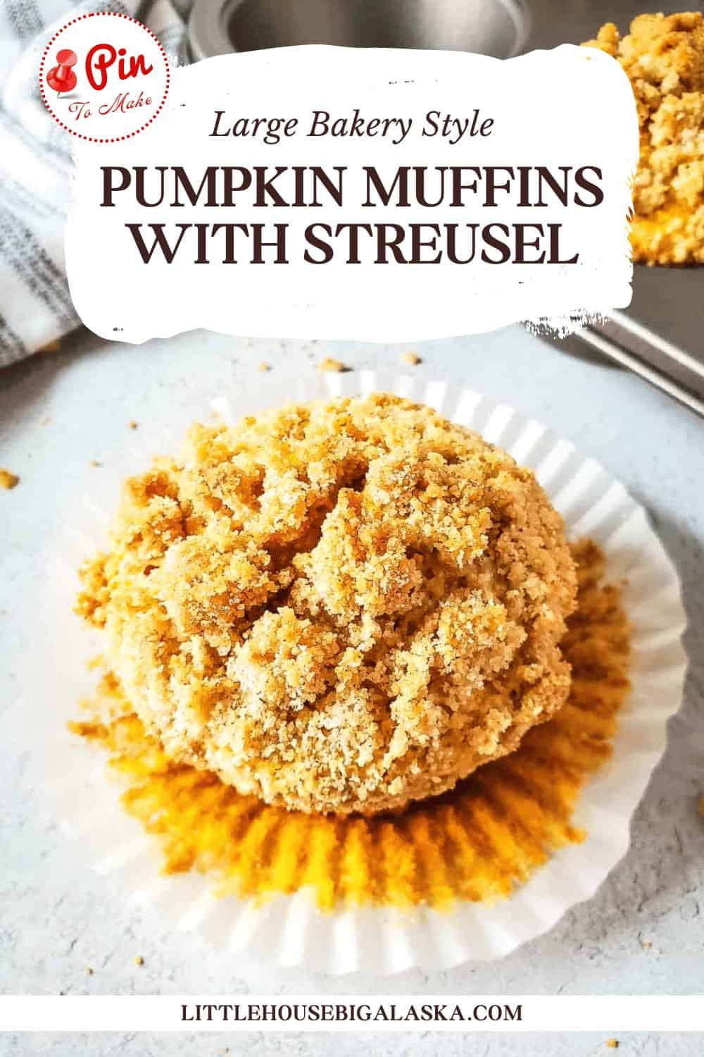 A pumpkin muffin with streusel topping on a white cupcake liner. The text above reads "Large Bakery Style Pumpkin Muffins with Streusel." The branding reads "Little House Big Alaska.