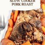 A slow cooker pot roast with carrots and potatoes, garnished with fresh herbs, presented on a white plate.