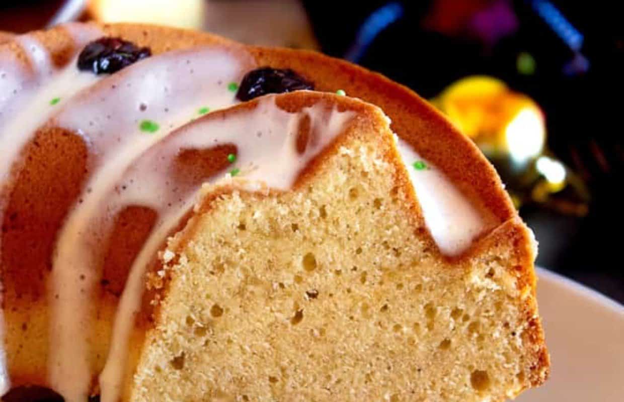 A slice of egnog bundt cake on a plate.