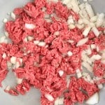 A pan with ground beef and chopped onions being cooked for a delicious Unstuffed Zucchini Casserole.