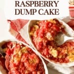 Two ceramic dishes of raspberry dump cake, with golden cake topping and vibrant red raspberry filling, rest on a red-striped cloth beside a partially visible baking dish.