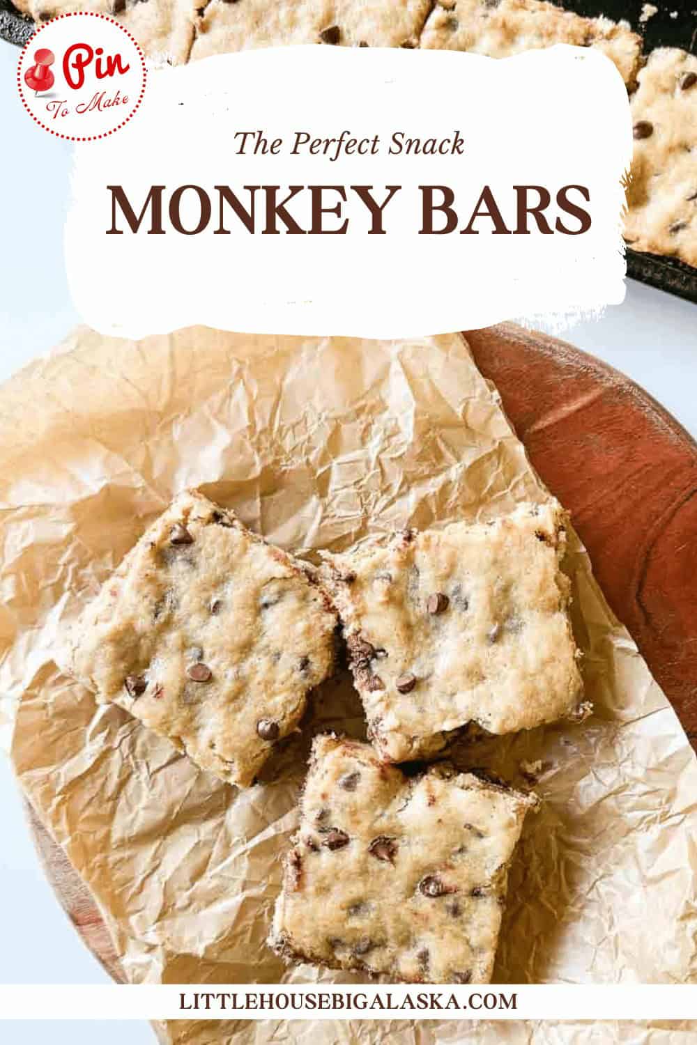 Several chocolate chip bars placed on brown parchment paper, with a tray of additional bars in the background. Text above reads "The Perfect Snack MONKEY BARS.