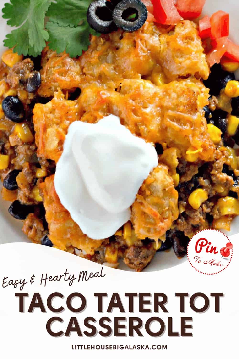 Close-up of a taco tater tot casserole topped with cheese, sour cream, olives, and tomatoes. Text overlay: "Easy & Hearty Meal: Taco Tater Tot Casserole." Website mentioned below.