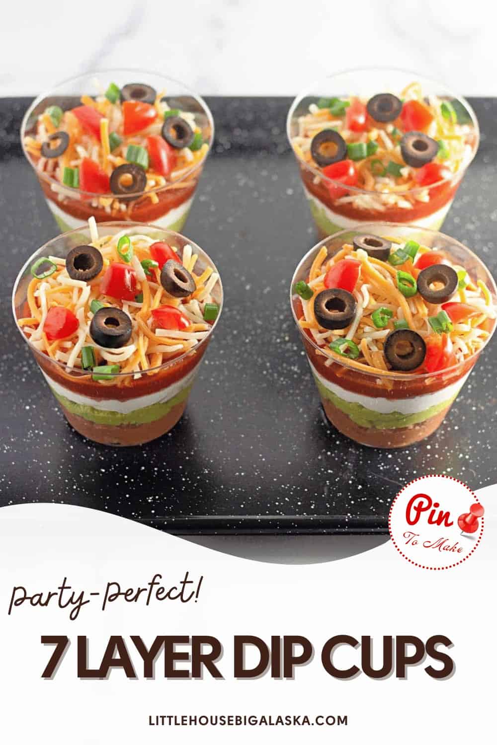 Four 7-layer dip cups topped with shredded cheese, tomatoes, and olives on a black tray. Text reads "Party-Perfect! 7 Layer Dip Cups" with a website link.