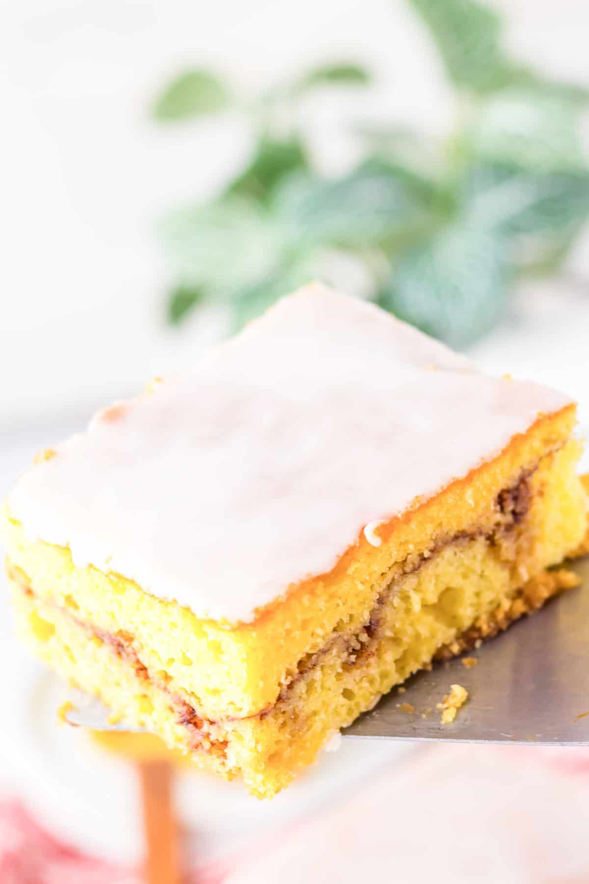 Cake on a plate with baking tools around it.